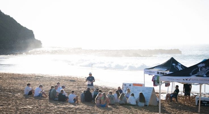Students sitting in a circle on North Avoca Beach